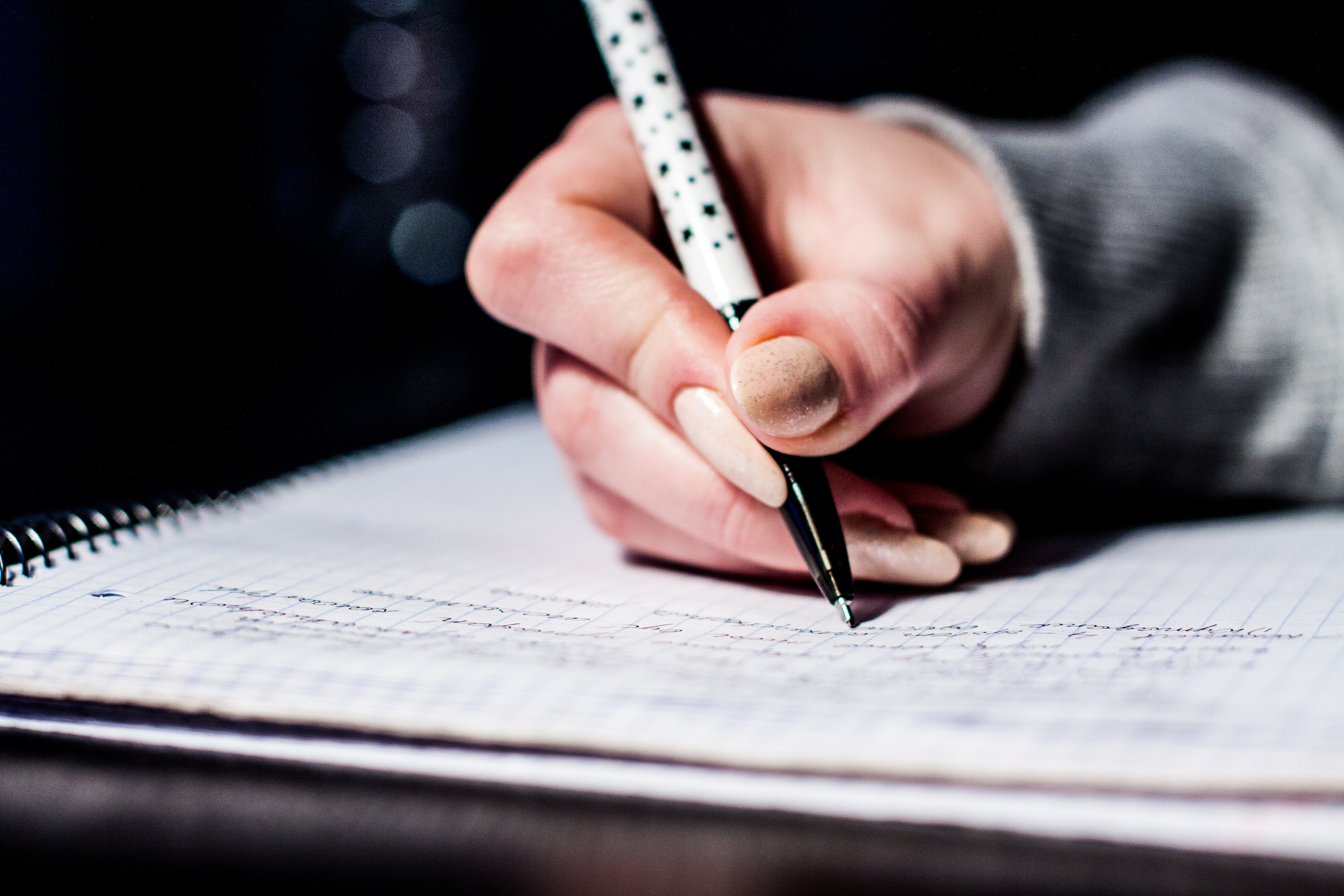 Girl writing in book at school