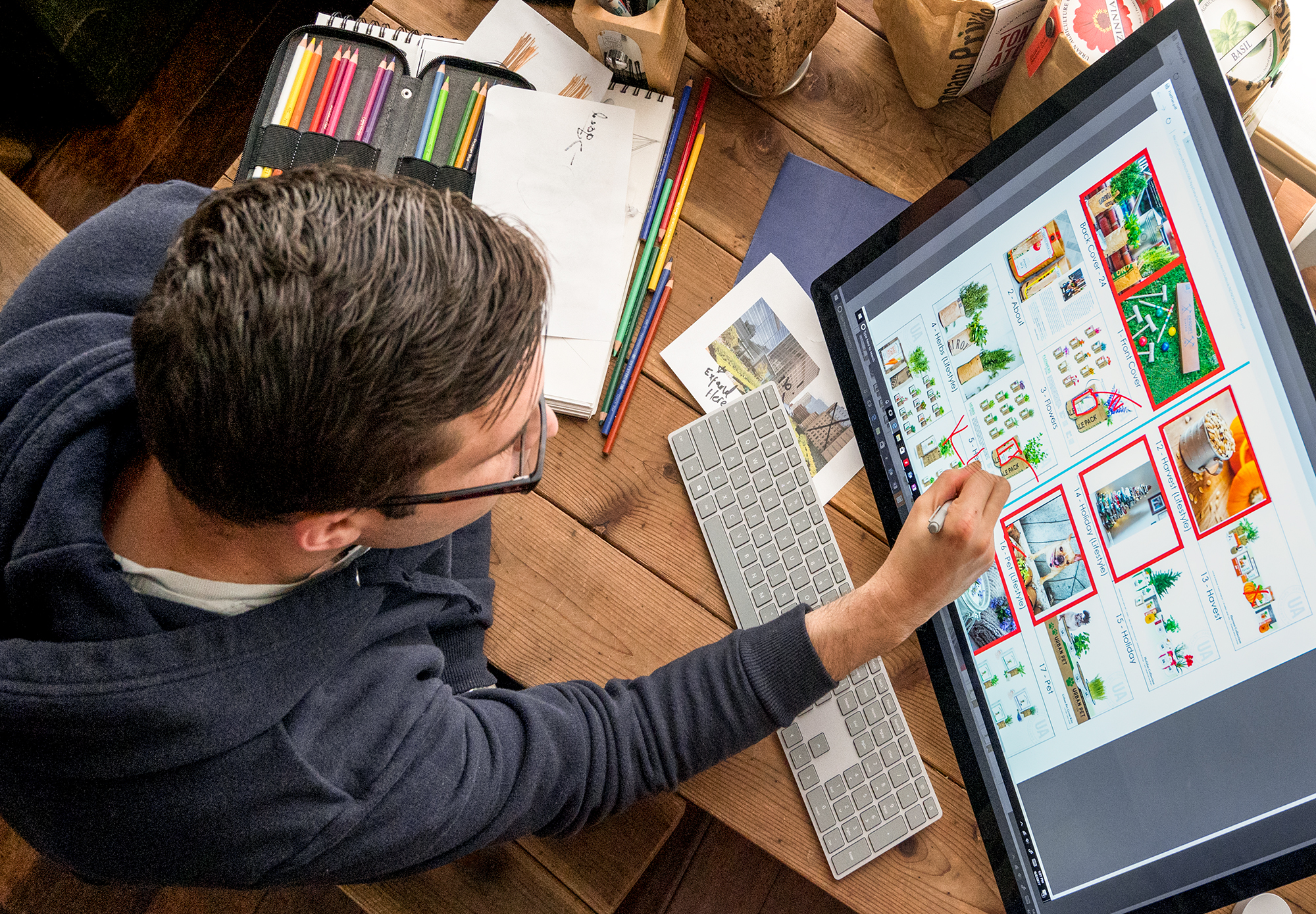 Man using Surface Studio on desk