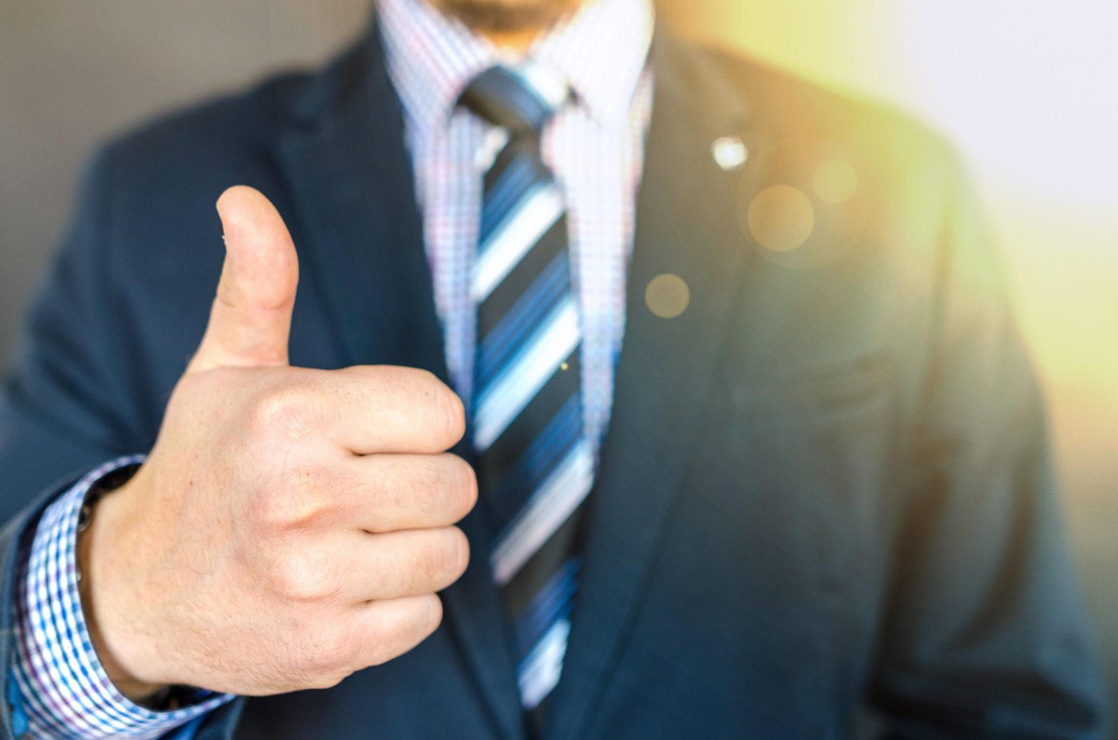 Man in suit giving thumbs-up