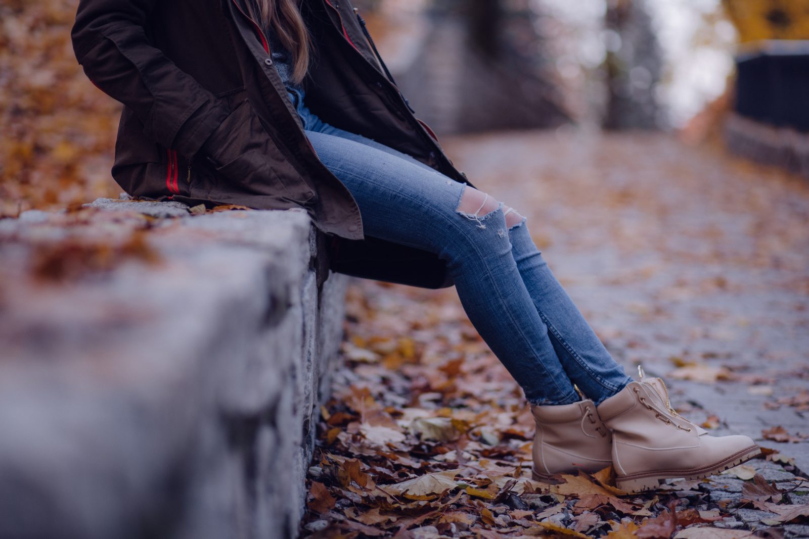 girl sitting on wall