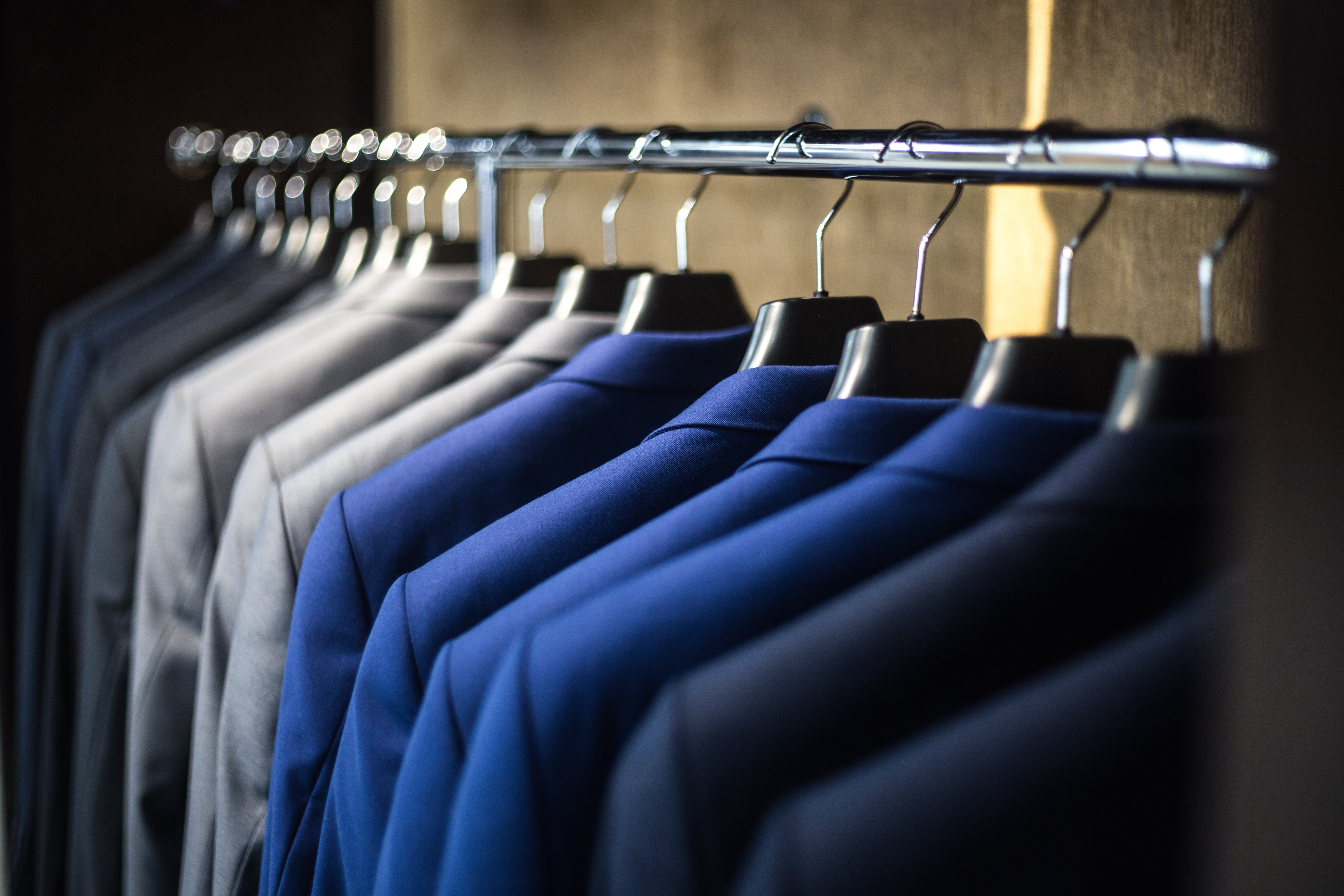 Suits on a rail in a clothes shop