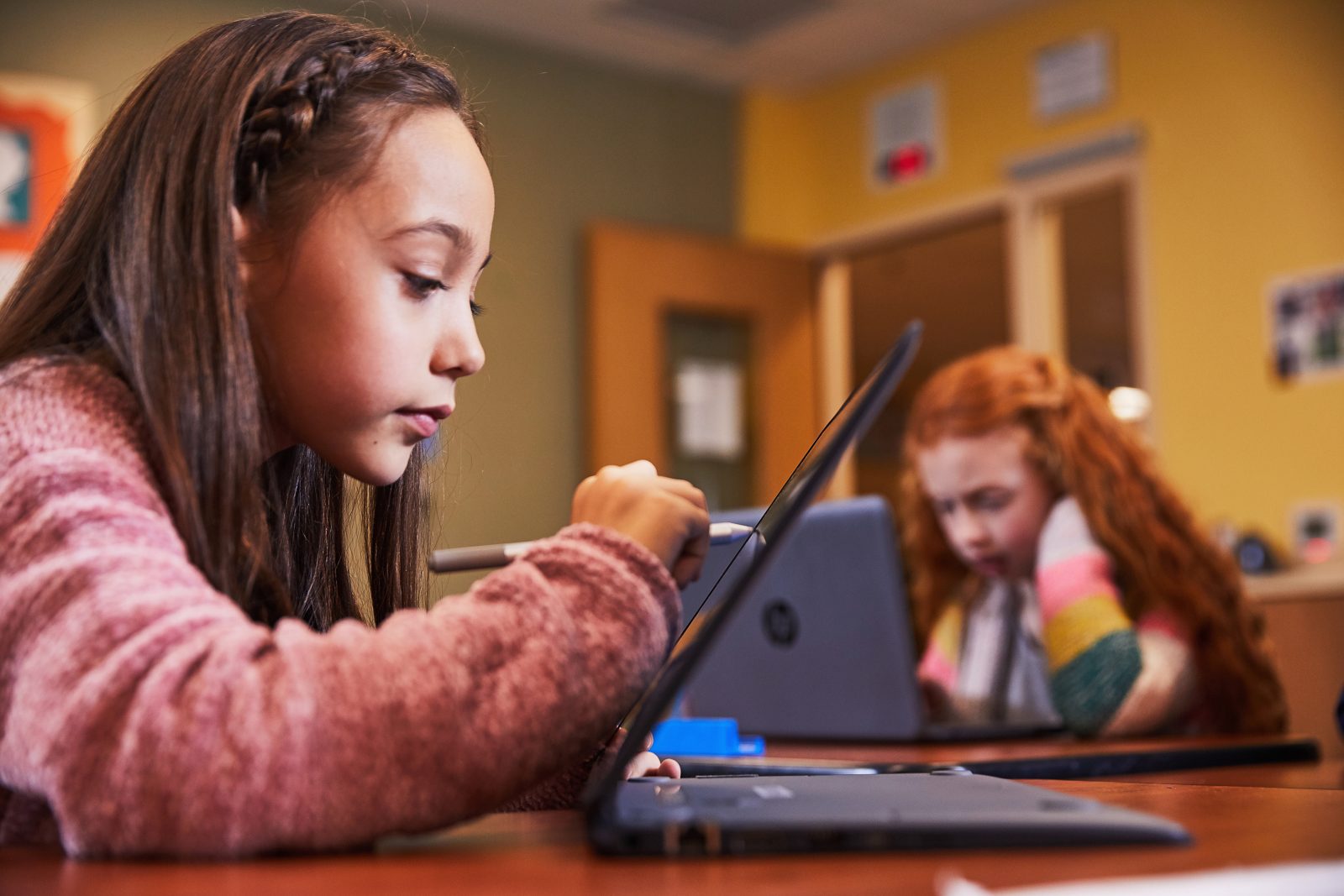 Girl at school using SUrface Pen to write on tablet