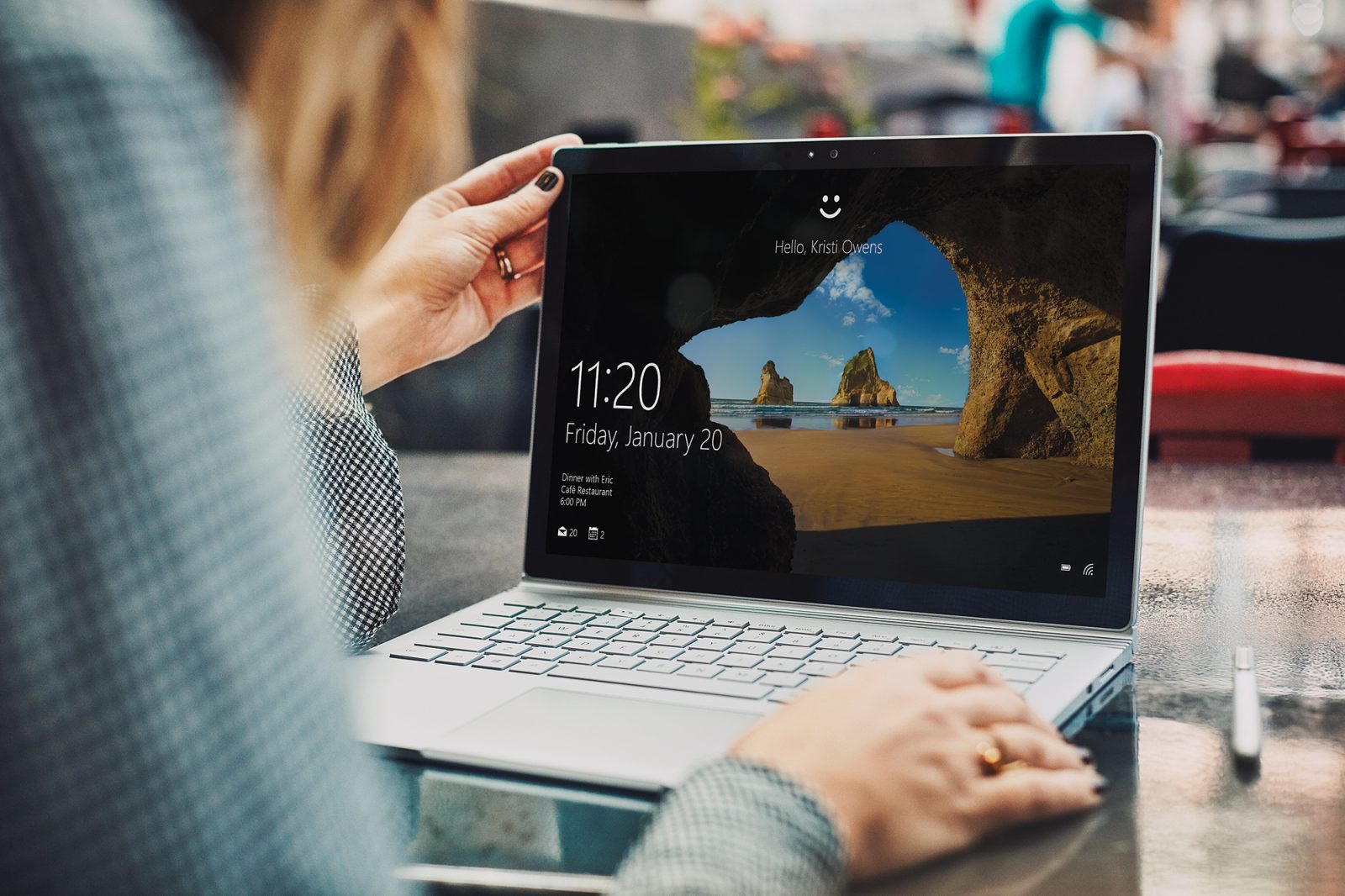 Woman signing in to laptop using Windows Hello