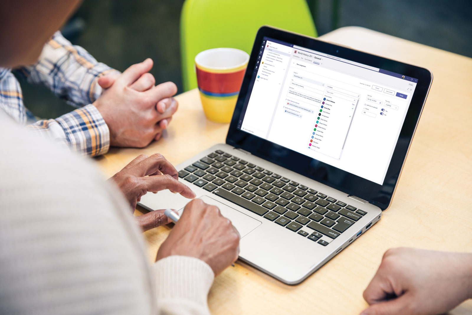 Man at desk typing on laptop
