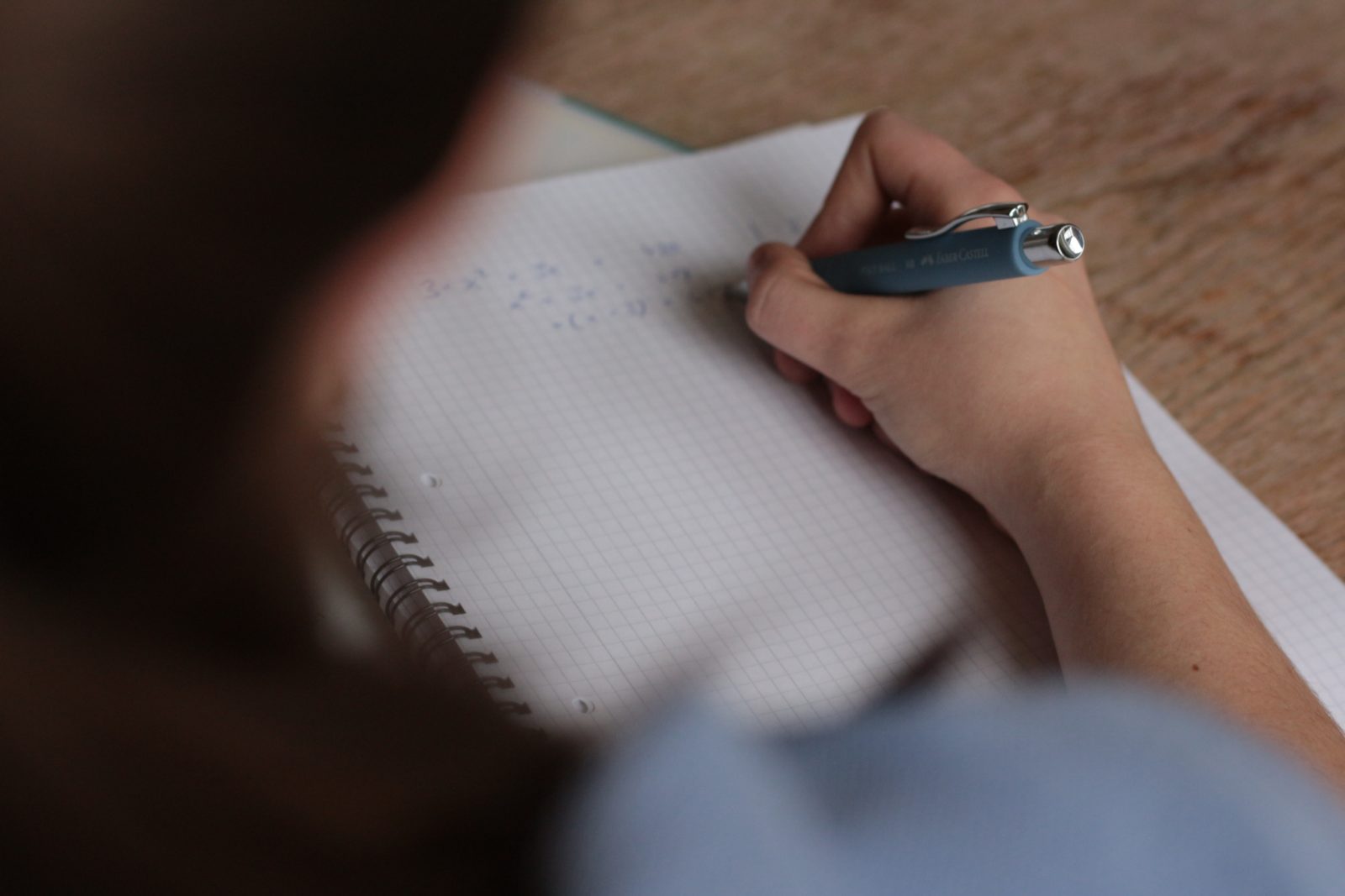 Girl in classroom writing in notebook