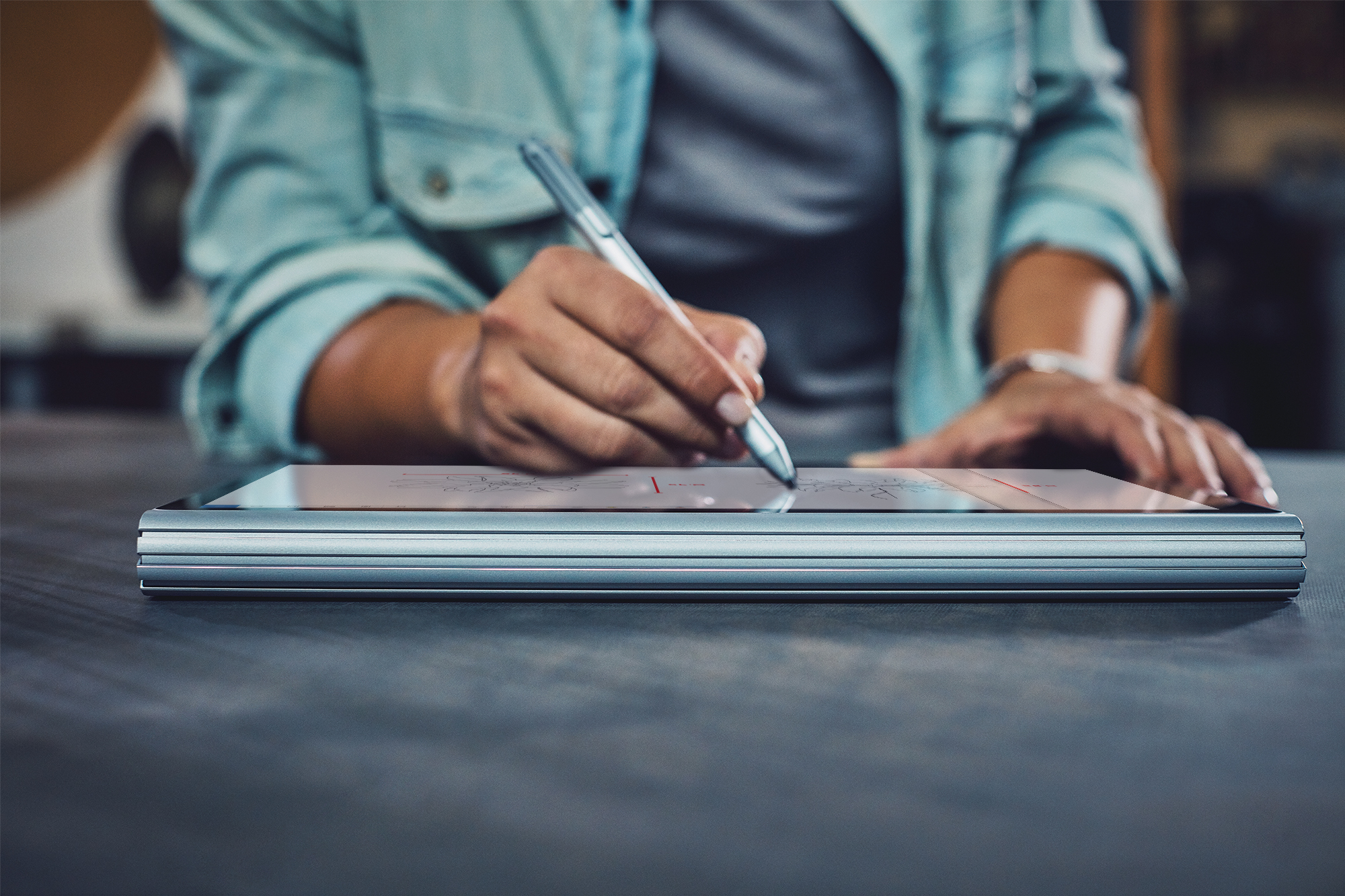 Woman using Surface Pen to draw on a Surface Book