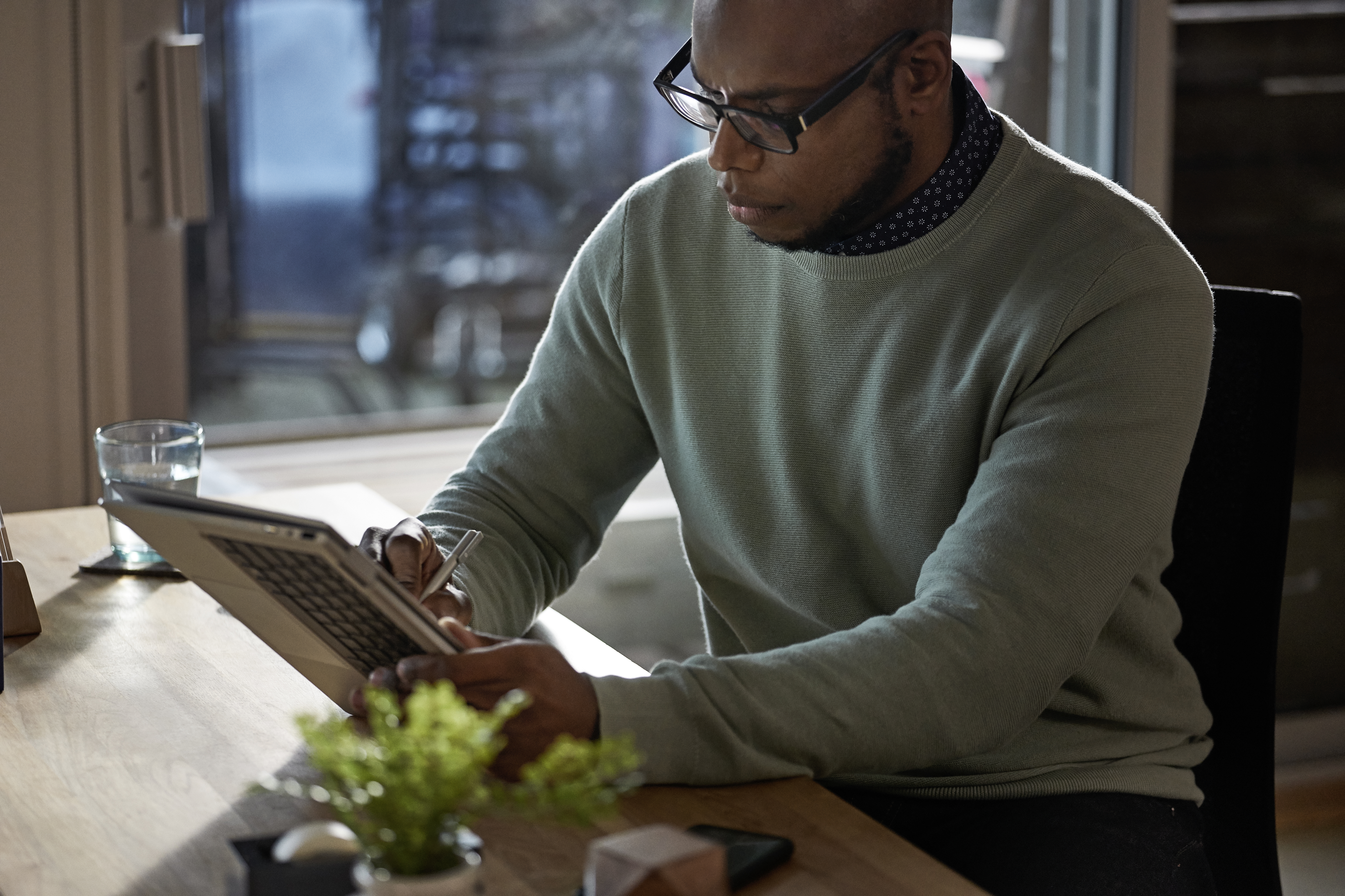 Man sitting down using tablet computer