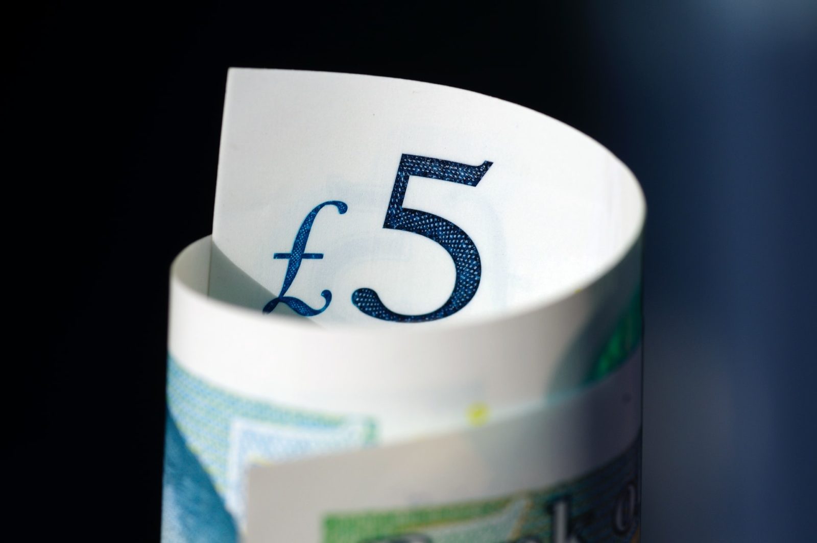 Close-up of a rolled-up five pound note