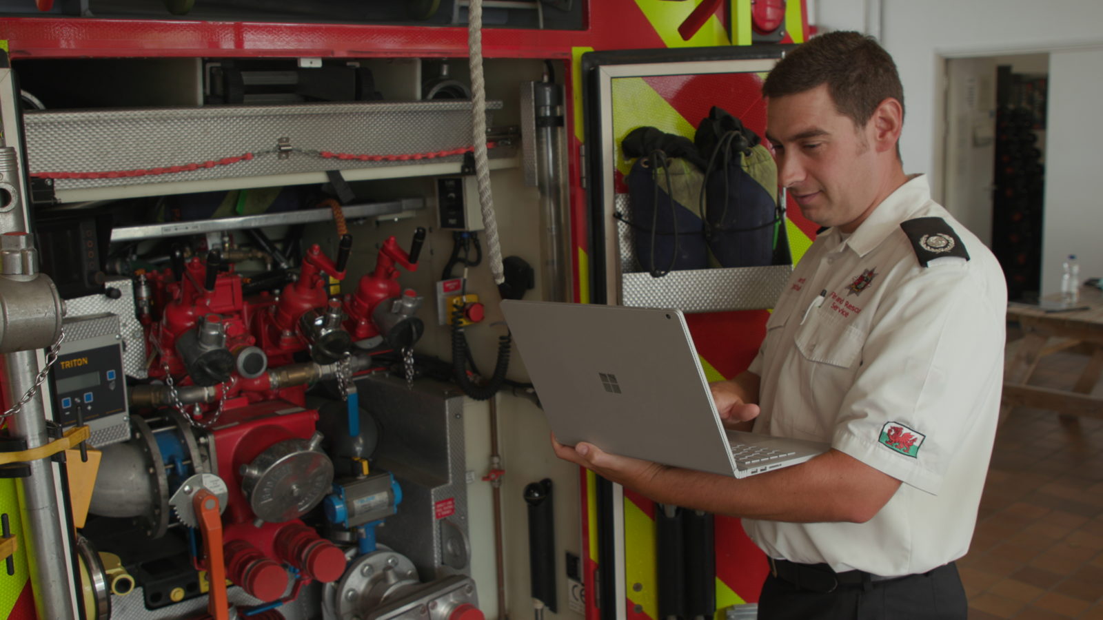 A fire officer from Mid and West Wales Fire and Rescue Service uses a Surface Book at Llanelli Fire Station