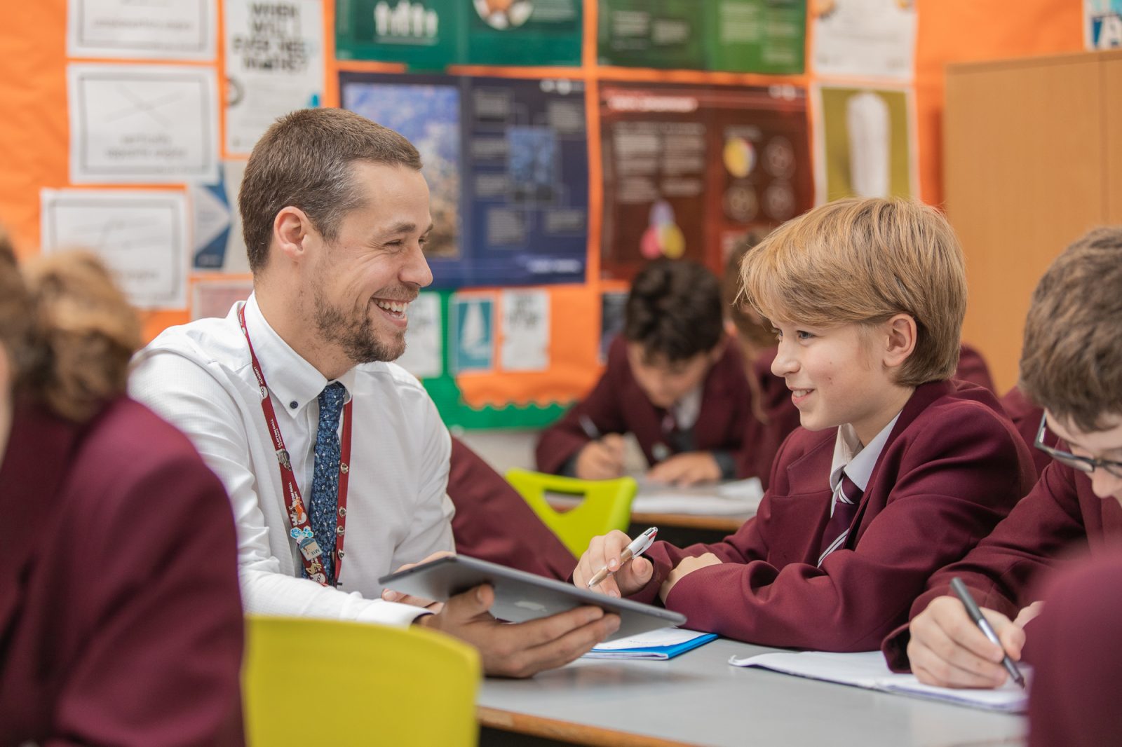 A teacher and student at Clayton Hall Academy use a tablet in a lesson