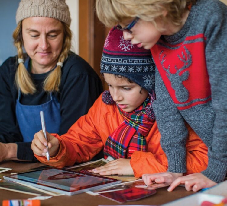 Woman and children working on tablet computer