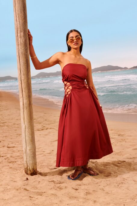 Young woman on beach wearing red dress