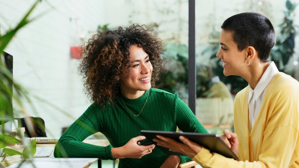 Women collaborating using digital tech