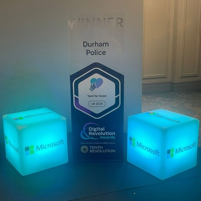 Image showing Durham Police as Winner of the 'Tech for Good' category at the Digital Revolution Awards 2925, with Microsoft logo cube lights next to the banner