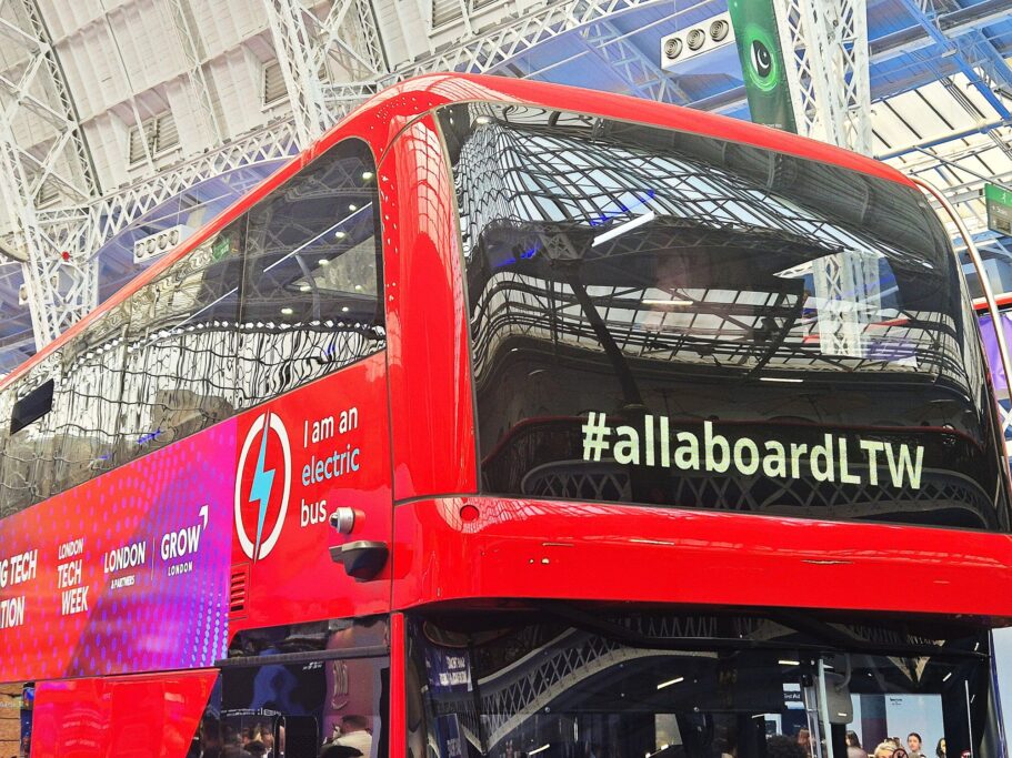 Red electric bus in the Olympia hall at London Tech Week 2025