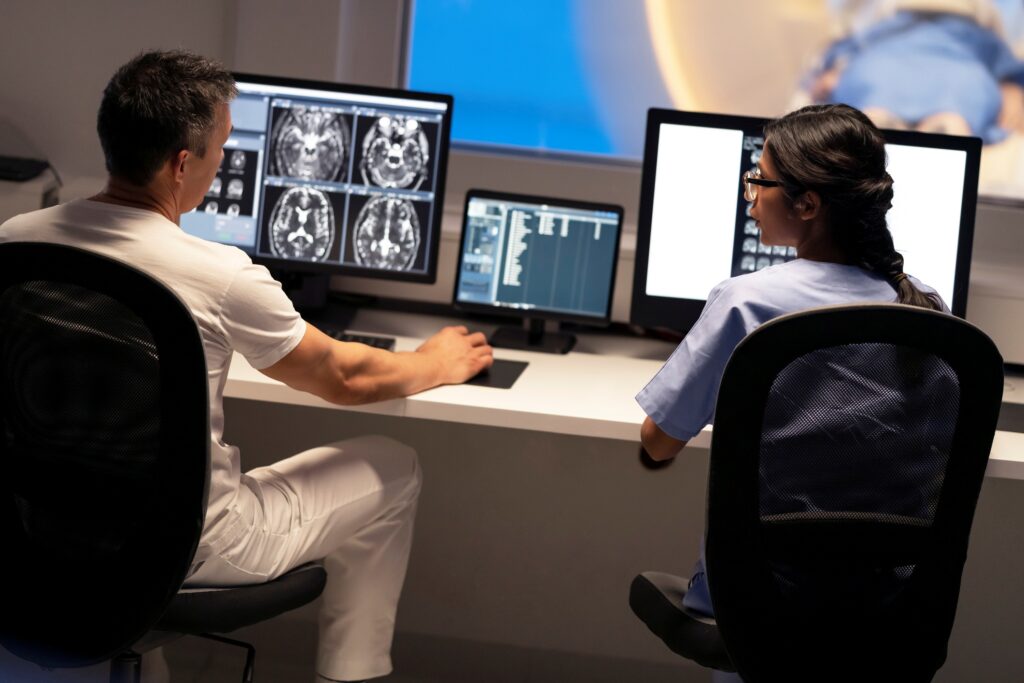Clinicians studying brain scans
