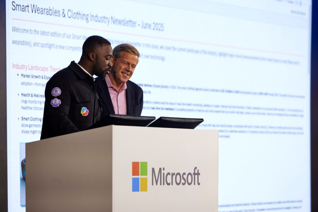 Microsoft Senior Solution Engineer Kwadwo Benko (left) shows Nick Parker, Microsoft Chief Business Officer and President of Worldwide Sales and Solutions, how Copilot can improve productivity