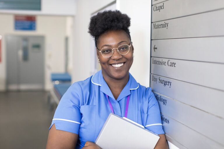 Nurse standing in front of hospital sign board
