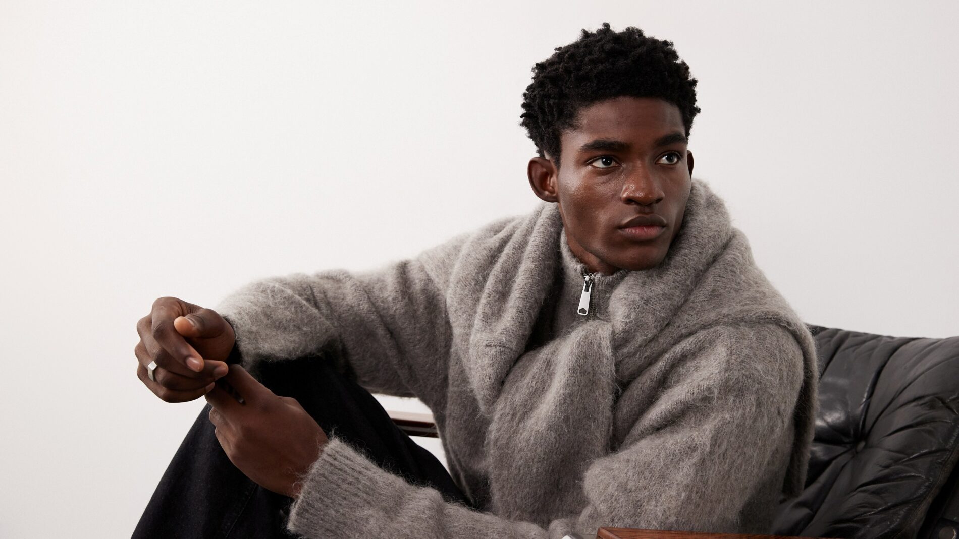 Young male fashion model wearing grey top