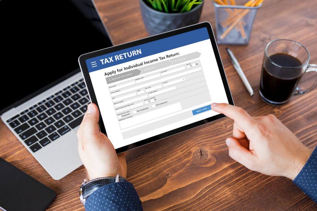 Someone on tablet filling in a tax return form