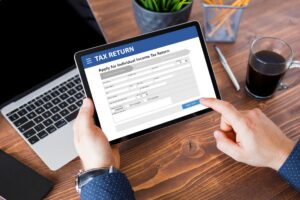 Someone on tablet filling in a tax return form