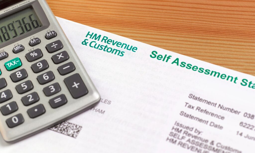 Close up of self assessment tax return and calculator