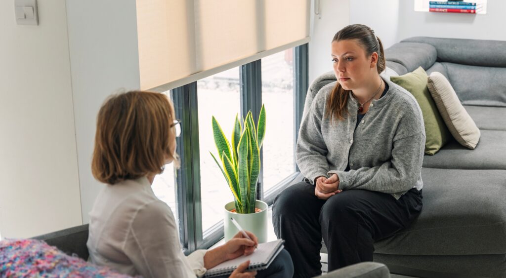 Social worker interviewing young woman