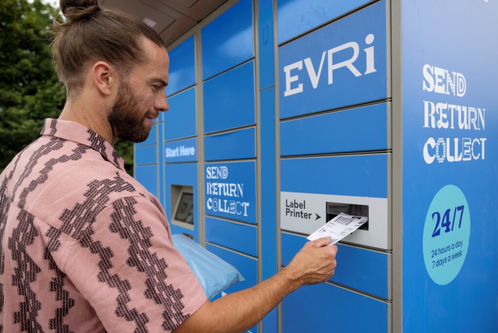 Man receiving printed label from Evri post station