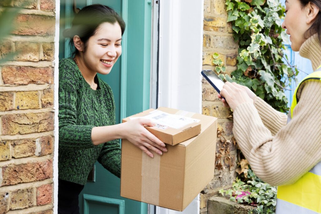Woman receiving parcels at front door